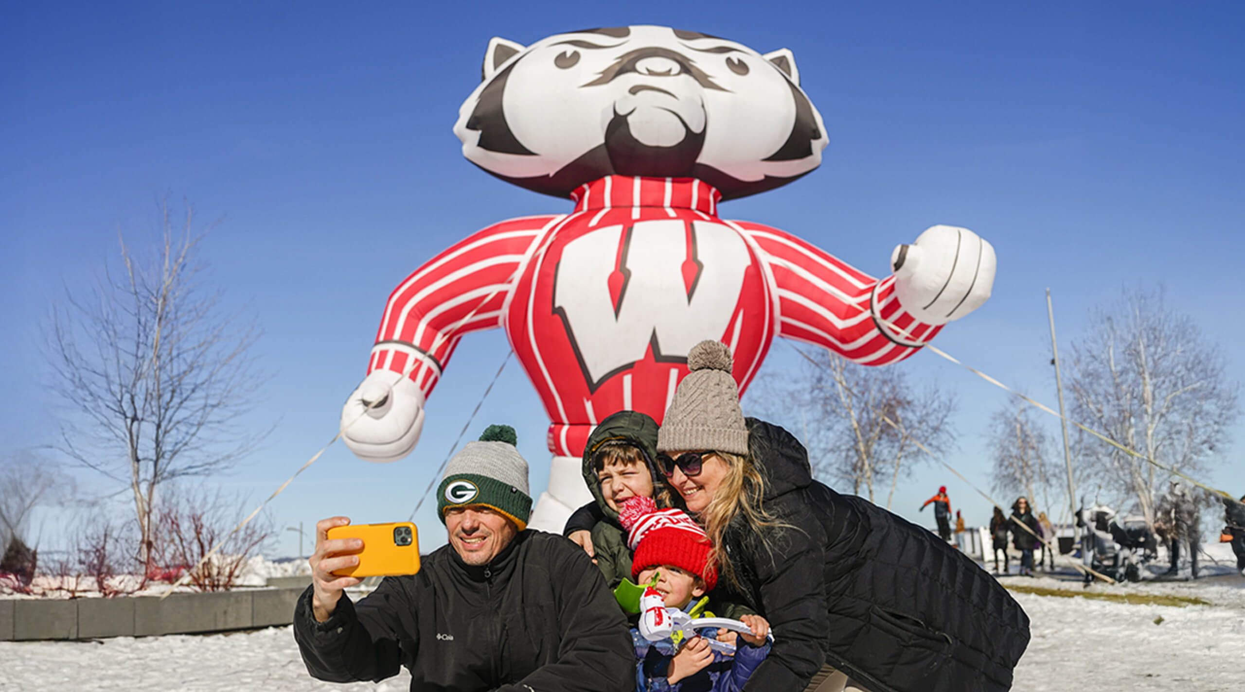 A family poses with with a giant inflatable Bucky