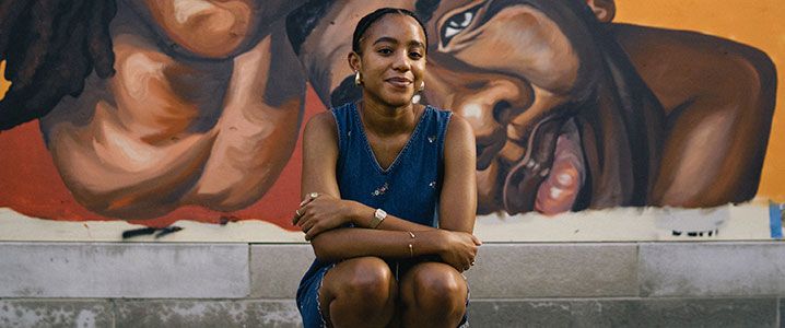 Shiloah Coley ‘20 sitting in front of her mural.