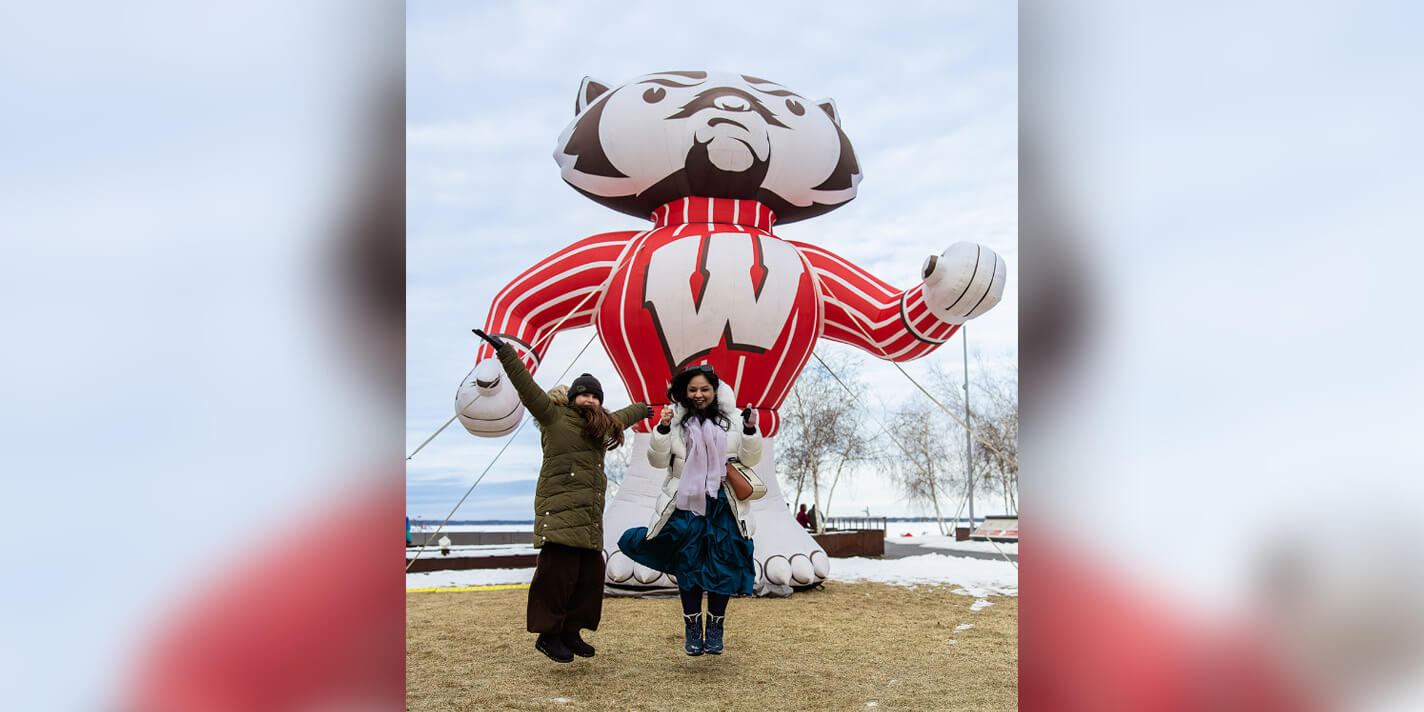 People jumping in front of an inflatable Bucky