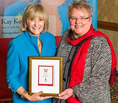 WAA President and CEO Paula Bonner MS'78 honors Kay Koplovitz with the Distinguished Alumni Award before the Downtown Rotary Club of Madison, December 2012