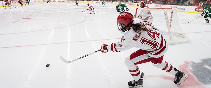 Wisconsin player Lauren Williams (14) passes the puck as the Wisconsin Badgers take on the Bemidji State Beavers during a women's hockey game at LaBahn Arena at the University of Wisconsin-Madison on Jan. 16, 2015.