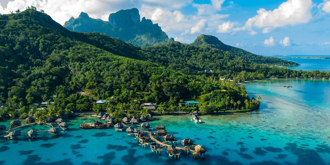 Bora Bora aerial drone image of travel vacation paradise and overwater bungalows